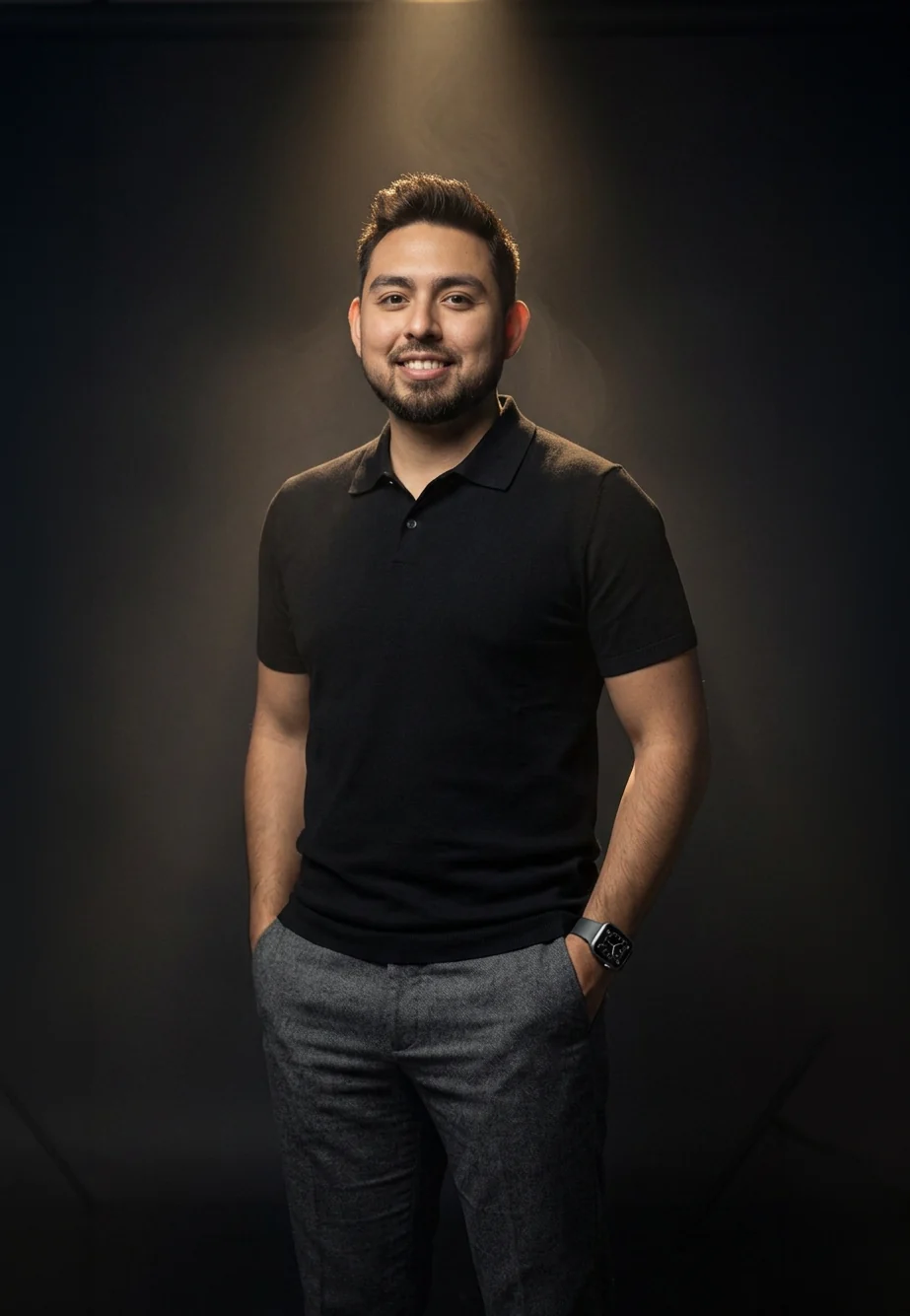 Retrato de Saúl Jaimes con playera polo negra sobre fondo oscuro